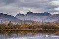 Beautiful Autumn landscape image of River Brathay in Lake District lookng towards Langdale Pikes with fog across river and vibrant Royalty Free Stock Photo