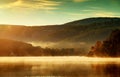 Beautiful autumn landscape, the lake in the morning fog Royalty Free Stock Photo