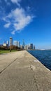A beautiful autumn landscape at Lakefront Park with the rippling blue waters of Lake Michigan, autumn trees, people walking