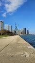 A beautiful autumn landscape at Lakefront Park with the rippling blue waters of Lake Michigan, autumn trees, people walking Royalty Free Stock Photo