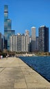 A beautiful autumn landscape at Lakefront Park with the rippling blue waters of Lake Michigan, autumn trees, people walking Royalty Free Stock Photo