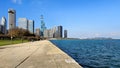 A beautiful autumn landscape at Lakefront Park with the rippling blue waters of Lake Michigan, autumn trees, people walking