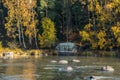 Beautiful autumn landscape with memorial stone on river Kymijoki near the Emperor Alexander lll fishing lodge Langinkoski. Kotka,