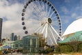 A beautiful autumn landscape at Navy Pier with a Ferris wheel, autumn trees, people walking, skyscrapers and office buildings Royalty Free Stock Photo