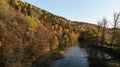 Beautiful autumn landscape. The river flows through the hills. Colored leaves on the trees. Autumn in Russia. Royalty Free Stock Photo