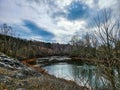 Beautiful autumn landscape with river, forest and blue sky with clouds. In Buford Dam Park. Royalty Free Stock Photo