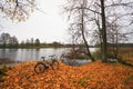 Beautiful autumn landscape with a river, a lone bicycle and fall Royalty Free Stock Photo