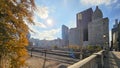 A beautiful autumn landscape with skyscrapers, hotels, and office buildings in the city skyline, autumn trees, railroad tracks