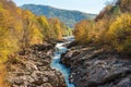 Beautiful autumn landscape with yellow trees at the riverside, a mountain range. Russia, Adygea, Lago-naki, Belaya river Royalty Free Stock Photo