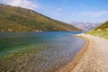 Beautiful autumn Mediterranean landscape - mountains, sea, deserted beach and blue sky. Montenegro, view of Bay of Kotor Royalty Free Stock Photo