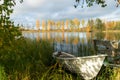 Beautiful autumn morning landscape with old rowing boat and Kymijoki river waters. Finland, Kymenlaakso, Kouvola Royalty Free Stock Photo