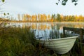 Beautiful autumn morning landscape with old rowing boat and Kymijoki river waters. Finland, Kymenlaakso, Kouvola Royalty Free Stock Photo