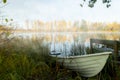 Beautiful autumn morning landscape with old rowing boat and Kymijoki river waters in fog. Finland, Kymenlaakso, Kouvola Royalty Free Stock Photo