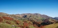 Beautiful autumn mountain landscape with colorful trees, snow peaks and old houses. Traveling through the mountains of Georgia Royalty Free Stock Photo