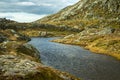 A beautiful autumn mountain landscape with a small lake. Natural scenery in Norwegian mountains. Royalty Free Stock Photo