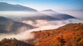 Beautiful Autumn mountain panorama. Morning thick fog cover valley Royalty Free Stock Photo