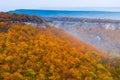 Beautiful autumn orange forest, mountain landscape in the fog on Royalty Free Stock Photo