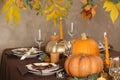 Beautiful autumn place setting and decor on table in room Royalty Free Stock Photo