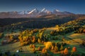 Beautiful autumn with a red and yellow trees under the Tatra Mountains at sunrise. Slovakia Royalty Free Stock Photo