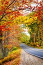 Beautiful autumn road winding through fall foliage in New England Royalty Free Stock Photo