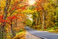 Autumn road winding through fall foliage in New England Royalty Free Stock Photo