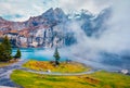 Beautiful autumn scenery. Thick fog gloving mountain peaks and lake.