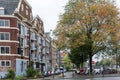 Beautiful autumn street after rain in Amsterdam. Typical Dutch architecture and trees with yellow and orange foliage Royalty Free Stock Photo