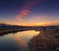 Beautiful autumn sunset with clouds reflected in the river. Royalty Free Stock Photo