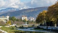 Beautiful autumn view of Sochi river, embankment with trees and snowy peaks of the Main Caucasian ridge. Sochi city center