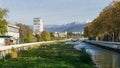 Beautiful autumn view of Sochi river, embankment with trees and snowy peaks of the Main Caucasian ridge