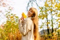 Beautiful autumn woman standing near colorful autumn leaves. Pretty happy cheerful model looking at camera. Young woman Royalty Free Stock Photo