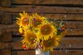 Beautiful autumnal bouquet of bright yellow sunflower flowers in white vase. Autumn still life with garden flowers Royalty Free Stock Photo