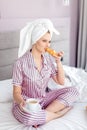 Beautiful awesome woman having breakfast in the hotel bed.