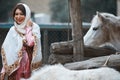 Beautiful azeri woman in traditional Azerbaijani dress standing with white horse Royalty Free Stock Photo