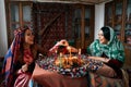 Beautiful azeri women and novruz tray with traditional pastry shekerbura and pakhlava