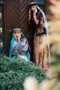 Beautiful azeri women in traditional Azerbaijani dress knocking the wooden door