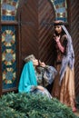 Beautiful azeri women in traditional Azerbaijani dress knocking the wooden door