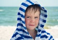 Beautiful baby with blue eyes on the sea background sweet and gentle. Cute child with atopic dermatitis on the background Royalty Free Stock Photo