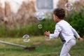 Beautiful baby boy with child soap bubbles posing photographer for cool photo Royalty Free Stock Photo