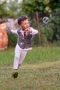 Beautiful baby boy with child soap bubbles posing photographer for cool photo Royalty Free Stock Photo