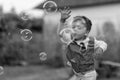 Beautiful baby boy with child soap bubbles posing photographer for cool photo