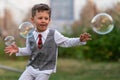 Beautiful baby boy with child soap bubbles posing photographer for cool photo Royalty Free Stock Photo