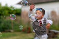 Beautiful baby boy with child soap bubbles posing photographer for cool photo Royalty Free Stock Photo