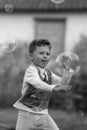 Beautiful baby boy with child soap bubbles posing photographer for cool photo