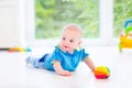 Beautiful baby boy with colorful ball and toy car