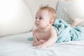 Portrait of beautiful baby boy after having bath lying on bed in bedroom Royalty Free Stock Photo