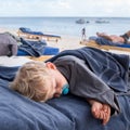 Infant boy sleeping on the beach Royalty Free Stock Photo