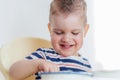 Beautiful baby eating soup with his hands Royalty Free Stock Photo