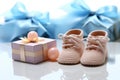 Beautiful baby gifts tiny bootees, blank postcard, and a pacifier on white