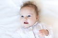 Beautiful baby girl with big blue eyes on white bl Royalty Free Stock Photo